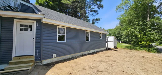 Addition with blue vinyl siding — complete