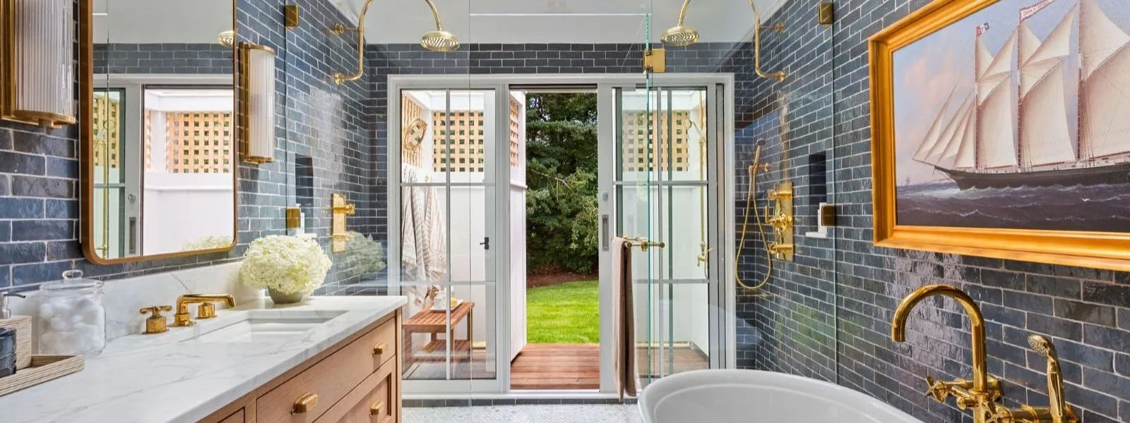 Dark blue subway tiles, gold accents, sailboat art, and garden views – McPhee Associates of Cape Cod.