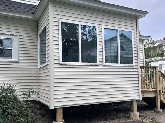 After: the finished addition with siding, trim and new windows
