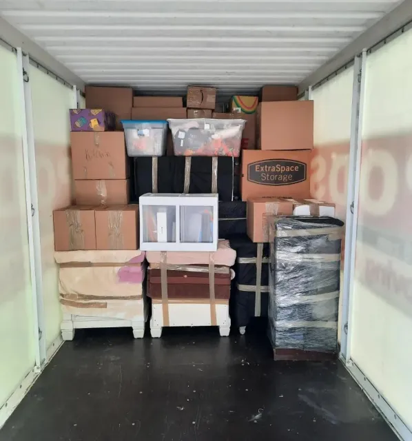 The inside of a moving truck filled with lots of boxes