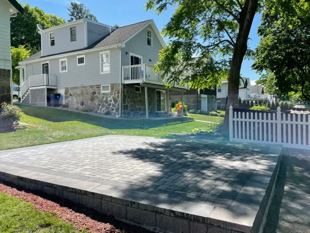 Finished paver patio with granite-look retaining wall