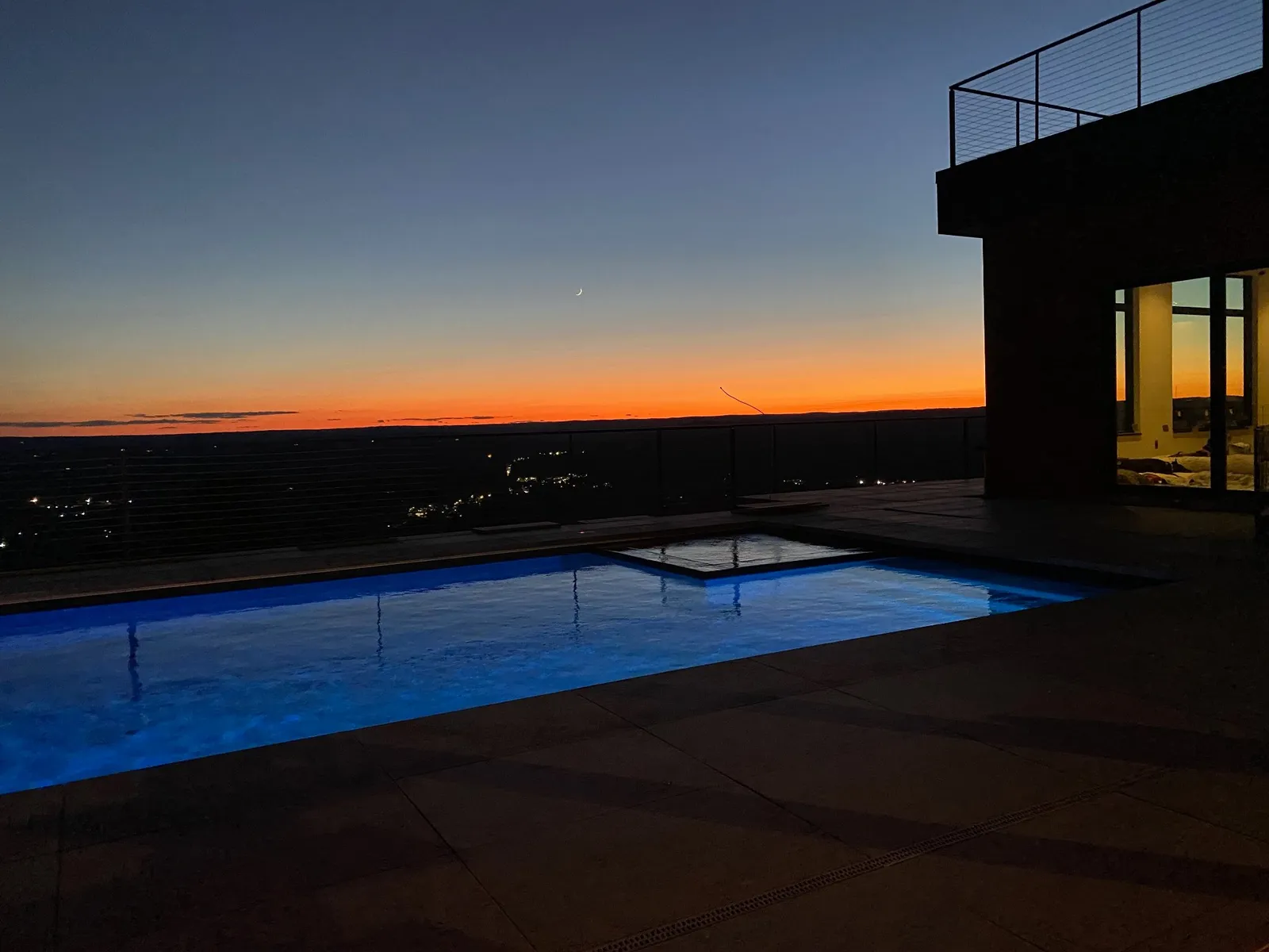 Customer luxury pool lit at dusk in Bloomfield, CT — Precision Aquatic Solutions
