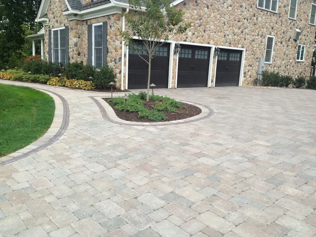 Driveway with pavers and landscaping