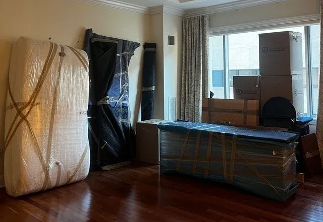 Furniture pad-wrapped and staged for an apartment move