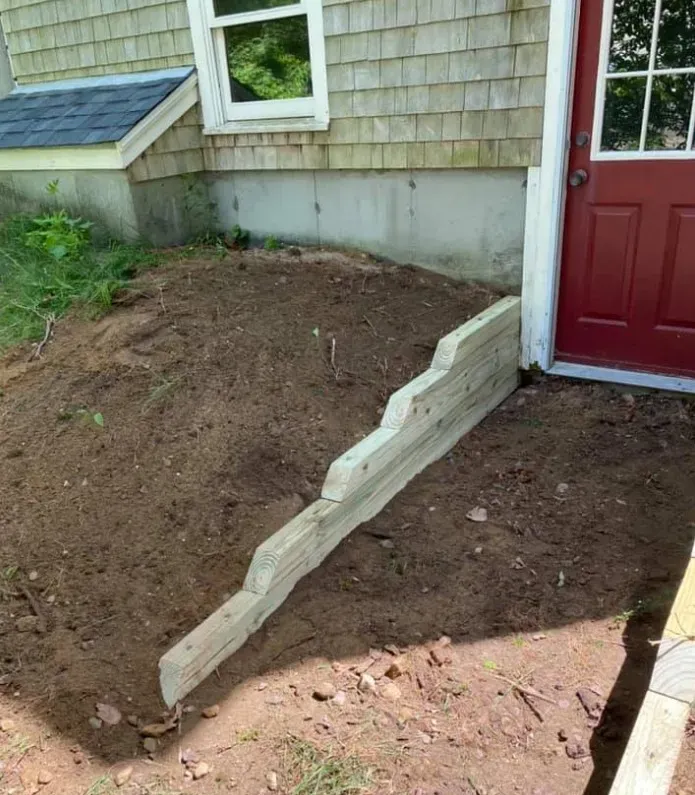 Timber edging and grade support installation near home