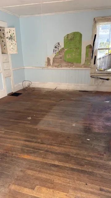 Emptied room with bare hardwood floor