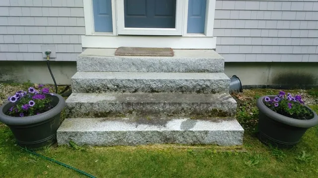 Granite steps before pressure washing in Grantham NH — moss and algae buildup