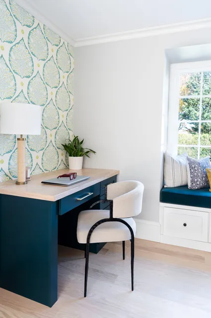 Jerusalem Road home office with rich blue-green built-in desk, botanical wallpaper accent wall, and window seat