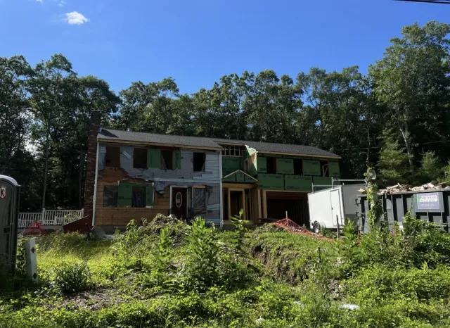 Rear home addition site preparation and foundation work in Massachusetts