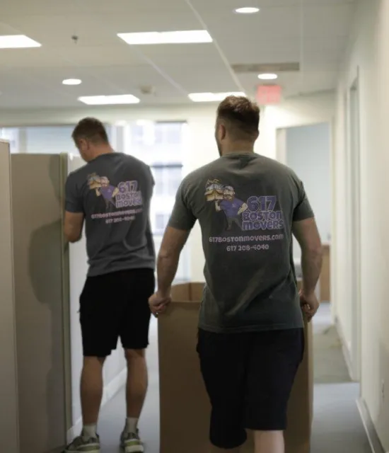 office movers carrying moving boxes in Boston