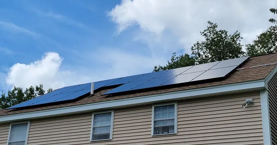 A house with a lot of solar panels on the roof