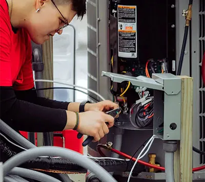 A Robies electrician performing electrical panel upgrades and wiring services, demonstrating Robies' comprehensive interior and exterior electrical solutions for Cape Cod homes