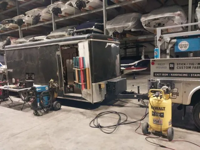 Warrior Welding mobile trailer and equipment inside fabrication facility, ready for certified on-site welding services