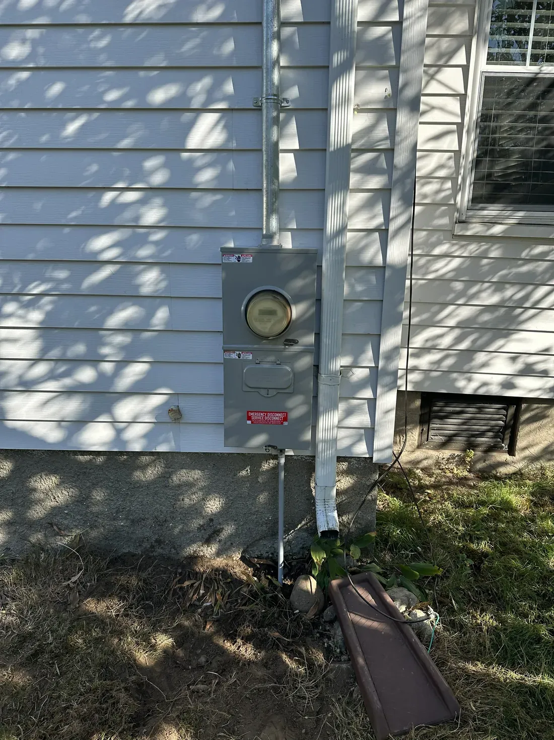 Exterior electrical meter and service disconnect installed on the side of a house