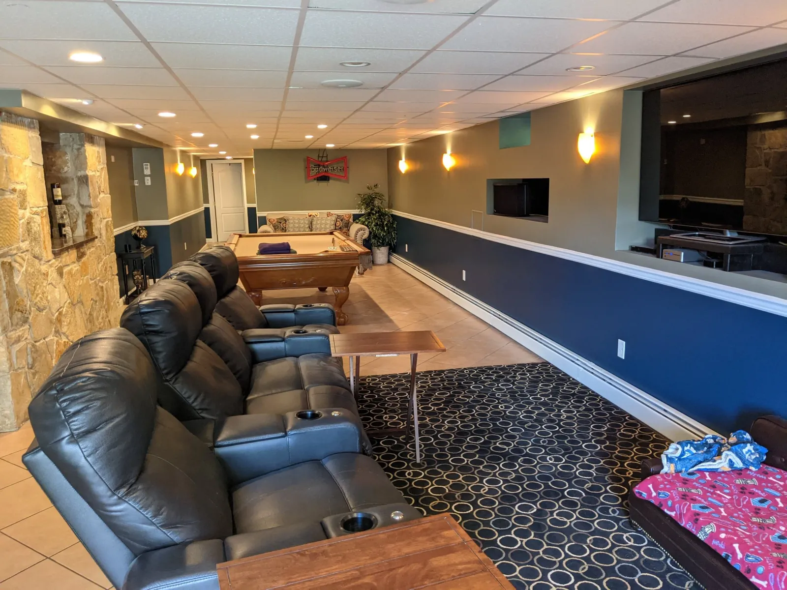 A large finished basement painted two colors.