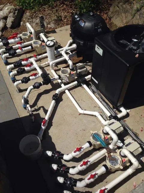 A bunch of pipes are laying on the ground