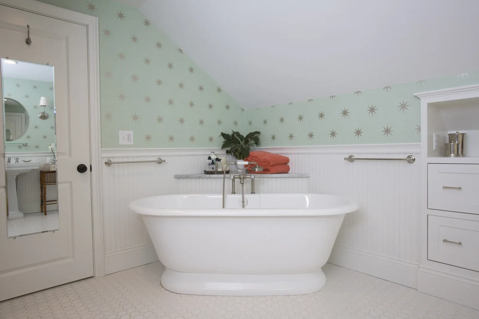 Bathroom remodel by Oxland Builders in New Hampshire featuring a standalone tub and star-patterned wallpaper