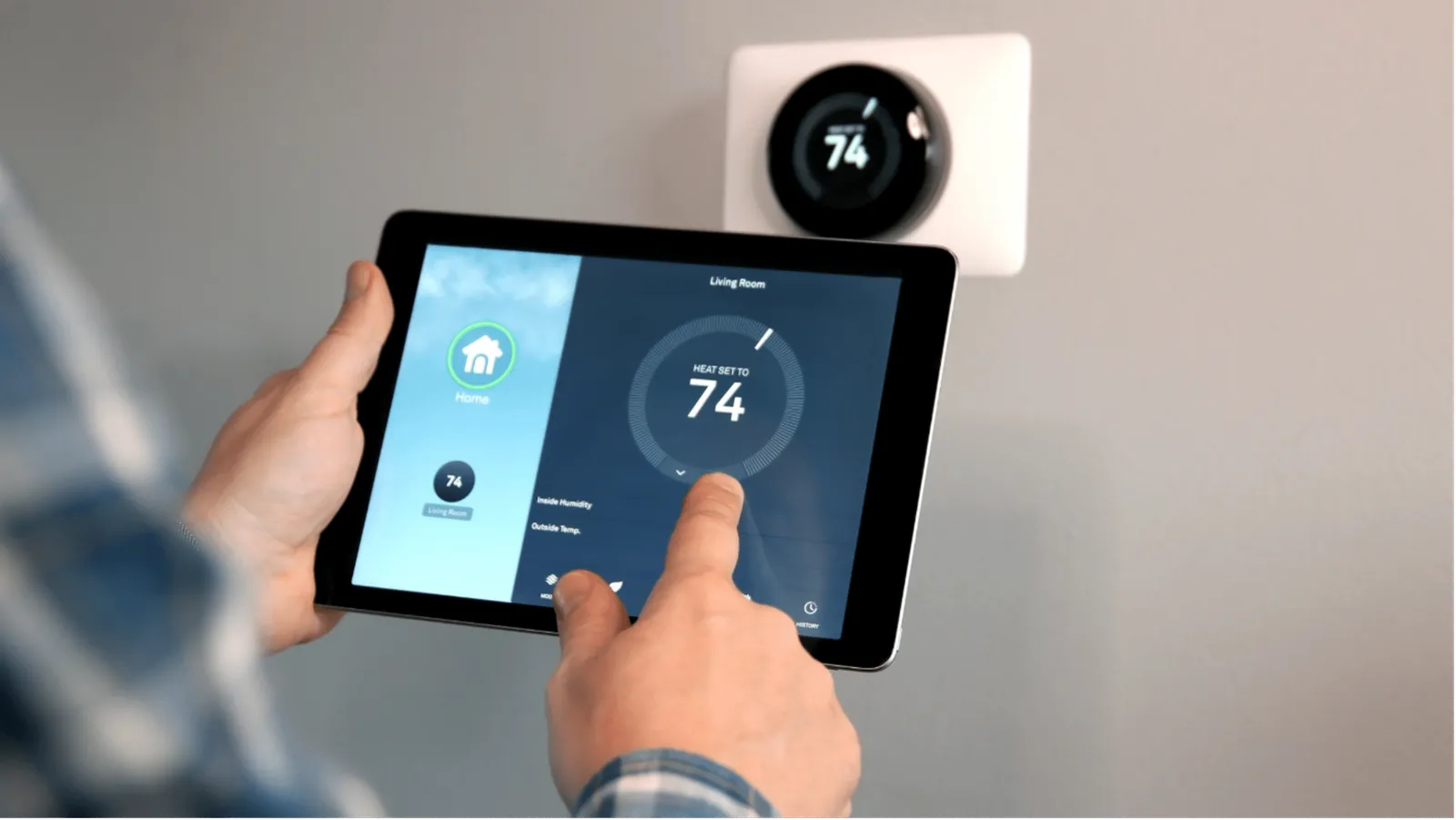 Man adjusting his thermostat on his tablet