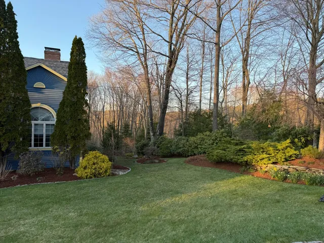 A neatly mowed green lawn beside a home in Keene, NH