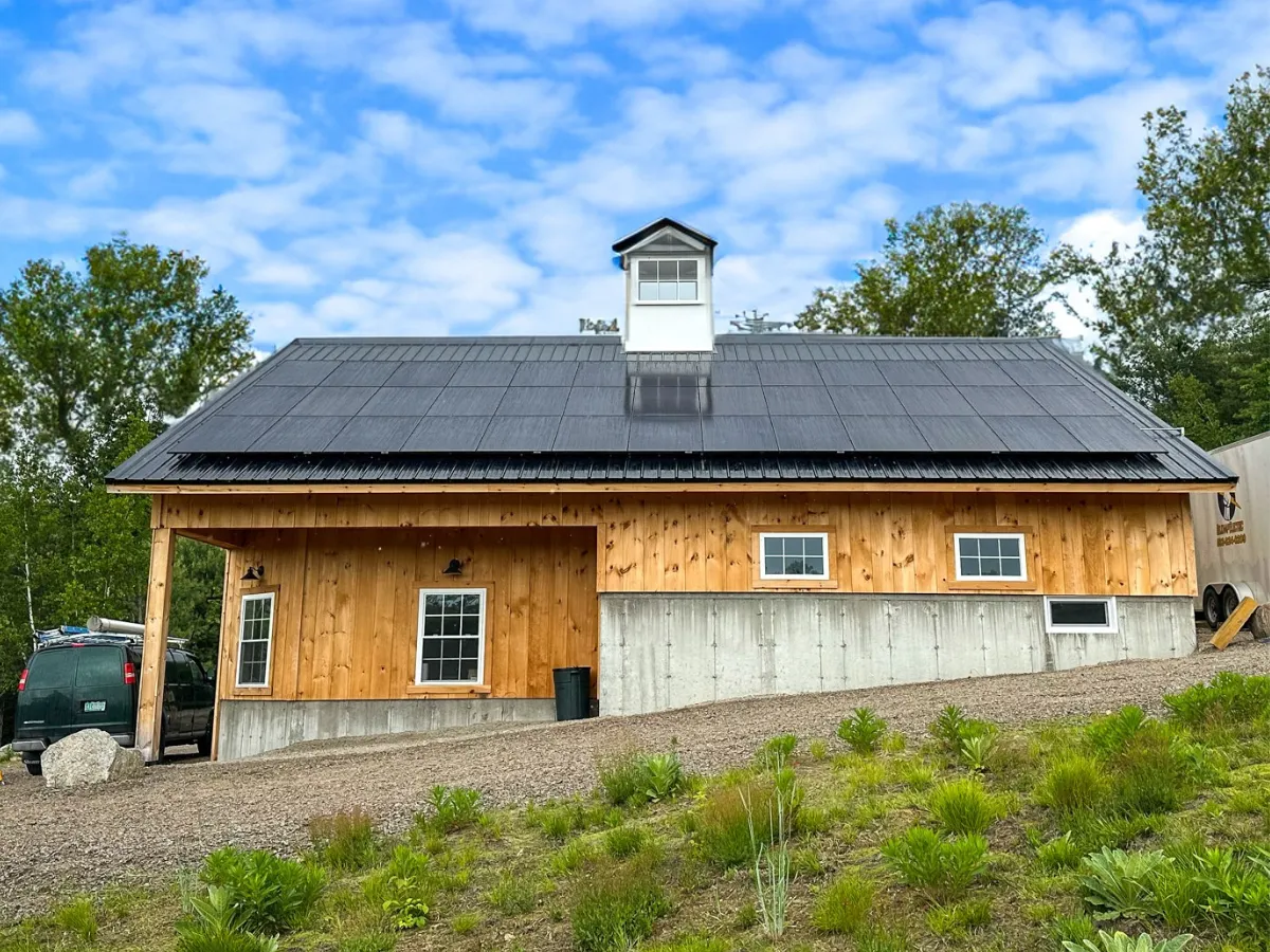 A full solar panel array on a timber-frame barn roof, providing the business with commercial solar power