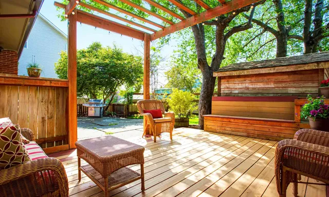custom-deck-with-patio-and-pergola-with-lighting-on-the-backyard-with-barbecue-grill-with-trees-and-plants-on-the-background-in-rochester-nh