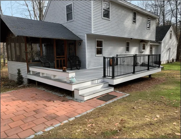 White house with porch and patio area.