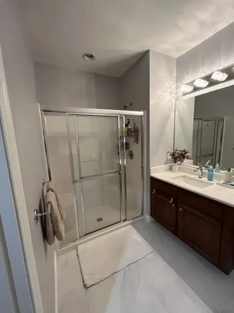 Bathroom remodel with glass shower enclosure and new vanity