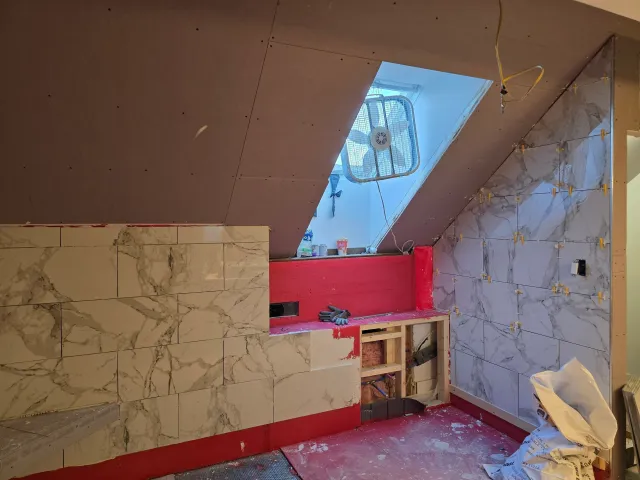 Bathroom tiling in progress during a remodel