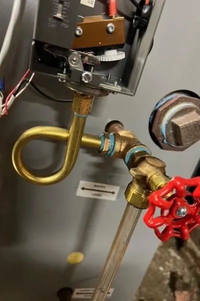 Brass loop tubing with red-handled valve