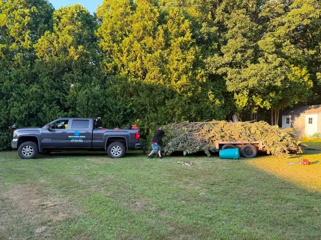 Crew loading brush onto a trailer after tree and property clearing
