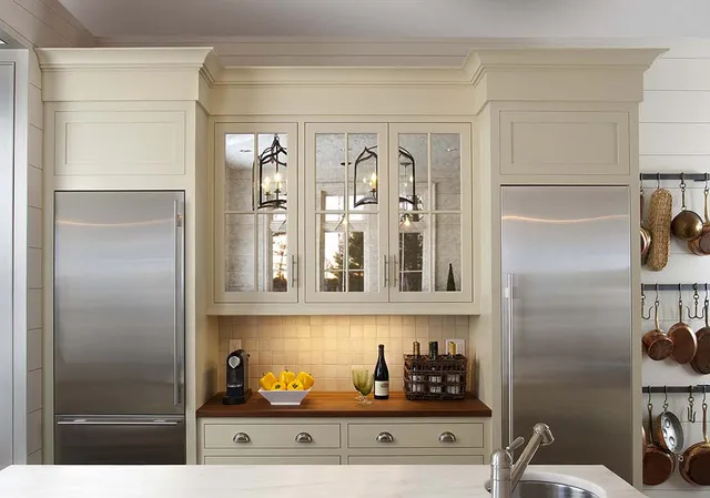 A kitchen with white cabinets and stainless steel appliances.