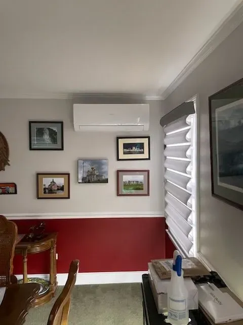 A room with red walls and a white air conditioner