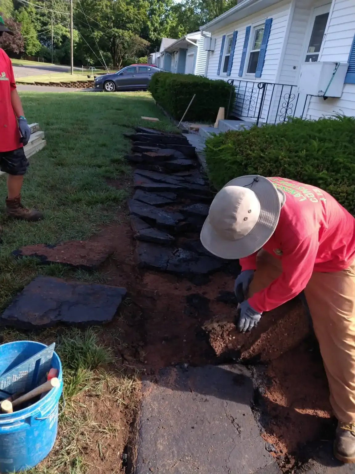 landscapers rebuilding walkway