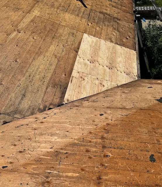 Roof decking repair in progress during an Amherst roof leak repair