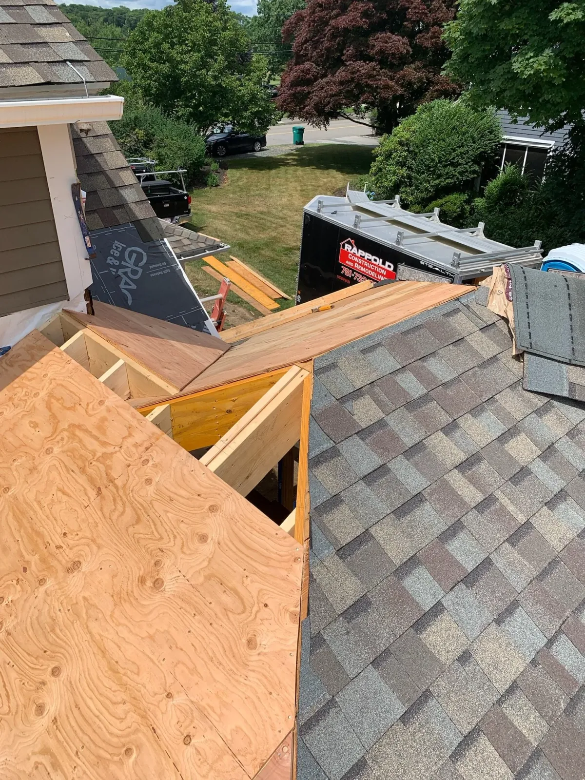 Roof construction site with plywood sheets and new roofing shingles, part of the roof is being replaced. Scituate, Norwell, Hanover, Hanson, Marshfield, South Shore. Massachusetts Local Construction Company.