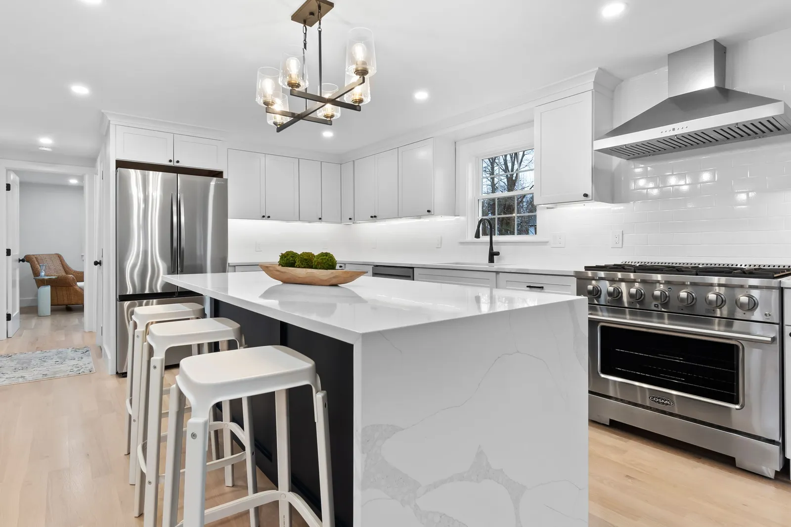 Remodeled kitchen with quartz island and professional range