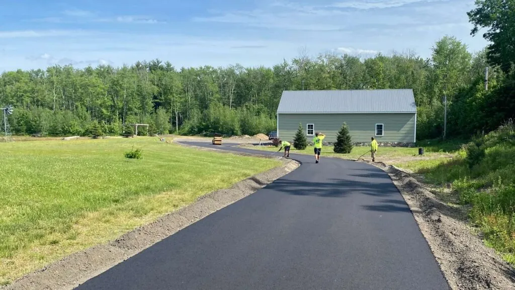 New asphalt driveway and rural landscape