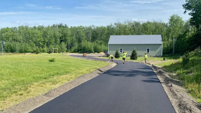 New asphalt driveway and rural landscape