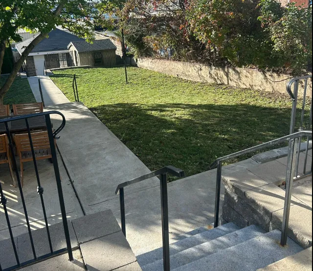 East Boston backyard cleanup with granite steps and restored lawn