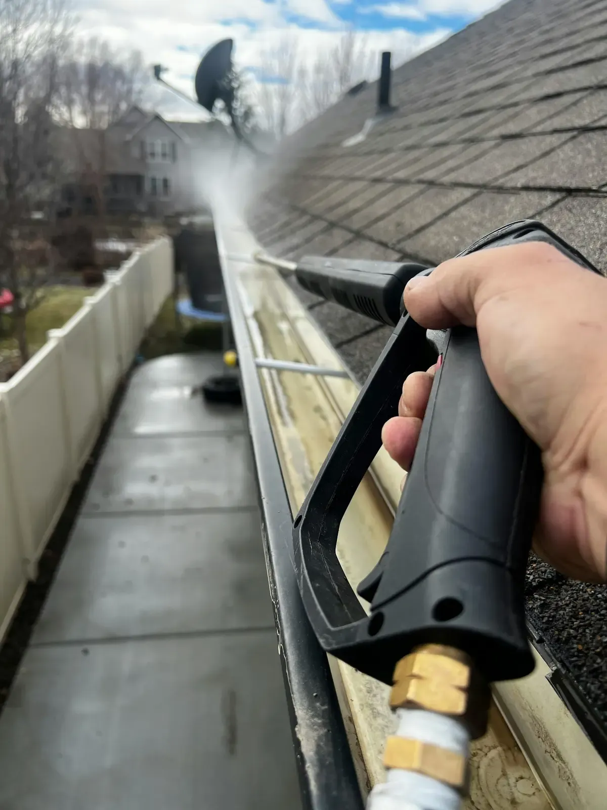 Home gutter being cleaned