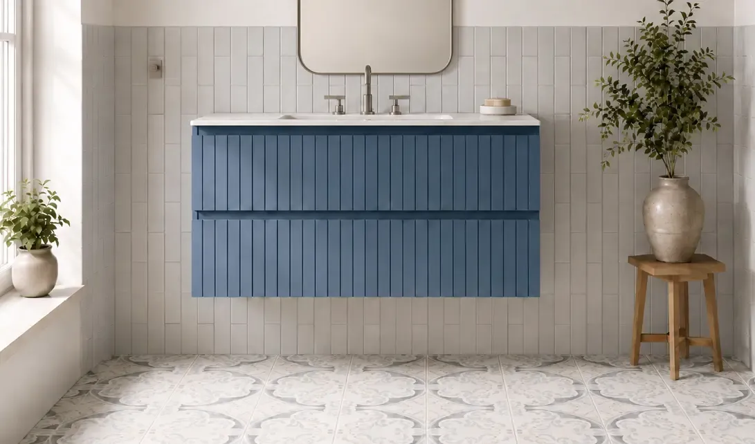 Modern bathroom vanity with white countertop, blue floating cabinet, and light tile walls