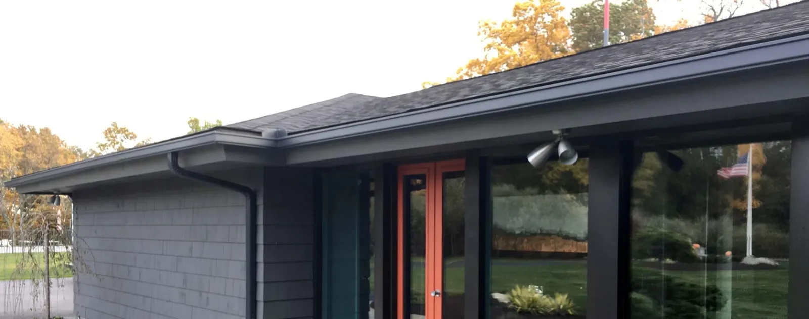 Dark gray home with orange trim
