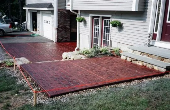 Red stamped concrete driveway and entry patio