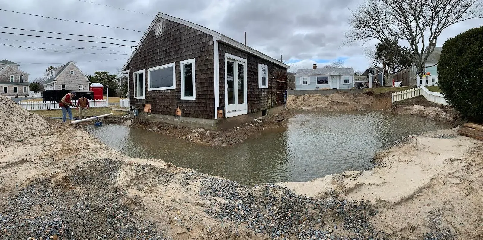 A house is surrounded by a large body of water