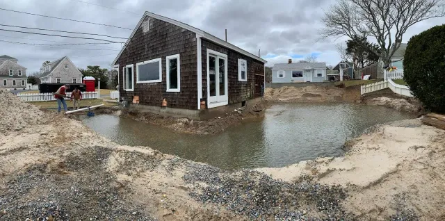 A house is surrounded by a large body of water
