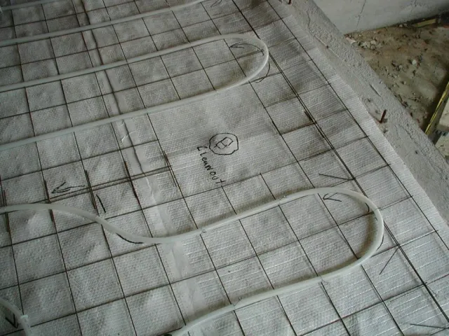 A close up of a heating system on a tiled floor
