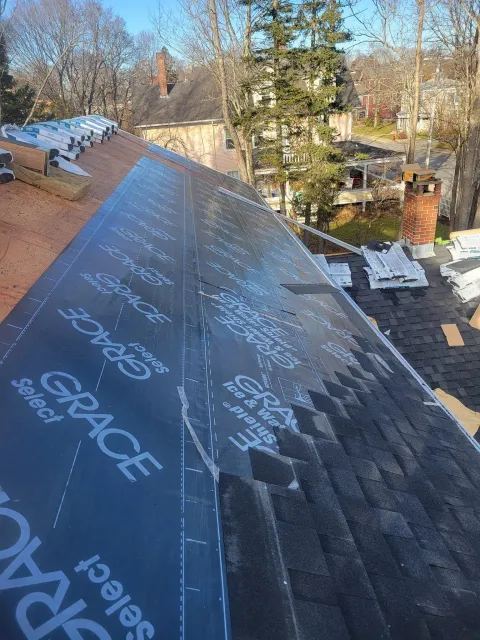 A roof with a lot of shingles being installed on it.
