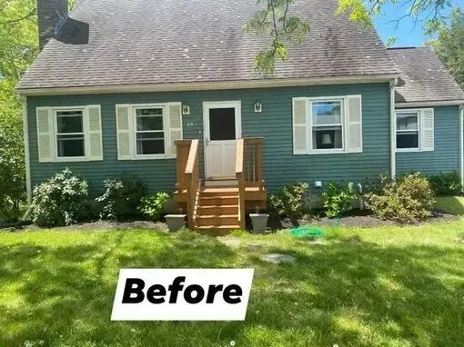 Front view of a teal house with white trim and wooden steps, labeled