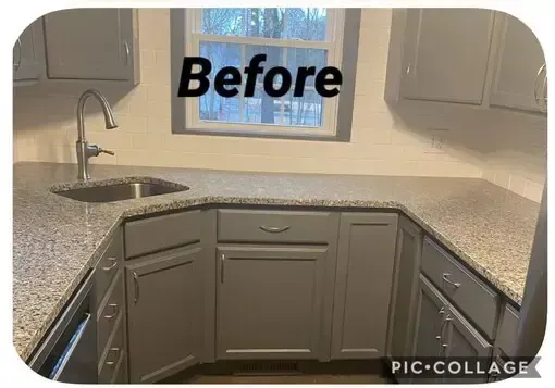 Before view of a small kitchen corner with gray cabinets, granite counters, and a sink beneath a window