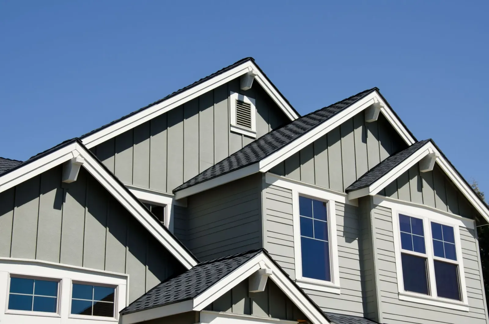 The roof of a house with a blue sky in the background